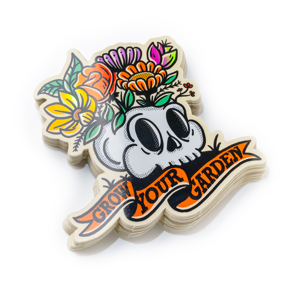 Sticker with a skull adorned with colorful flowers and the phrase "Grow Your Garden" in bold letters below.