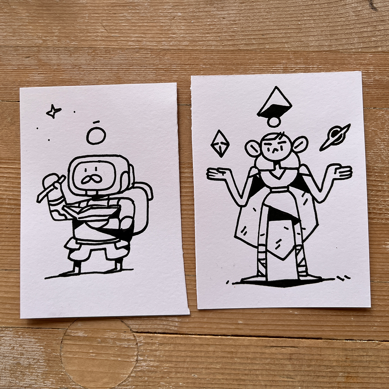 two characters on paper, one with an astronaut and the other a space monkey